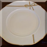 K46. Set of Richard Ginori chargers including 12 white with gold rim chargers, 2 white with gold ribbon charger, 4 gold chargers, 3 Griffe smokey and gold trim chargers - $240 